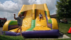 giant inflatable bouncy slide with kids sliding down