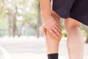 Cramp In Leg While Exercising. Sports Injury Concept